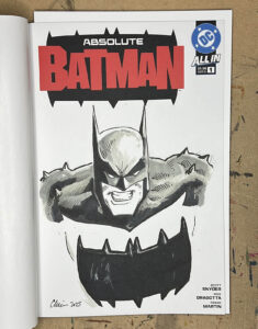 A grayscale portrait of a grimacing "Absolute Batman" character drawn in pen, ink, and alcohol markers on a comic book sketch cover.
